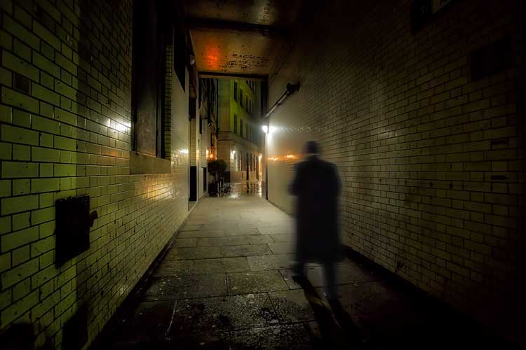 Richard Jones walking through an alleyway.